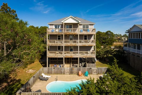 Back side of the house with heated swimming pool