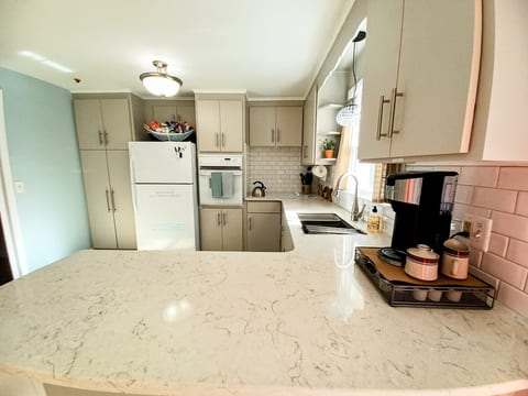 new kitchen refacing and quartz counterops, also new workstation sink and high faucet