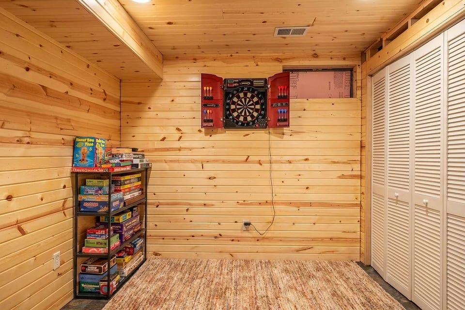 Cozy wood-paneled game nook with dartboard and board games