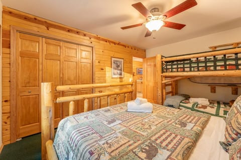Rustic bunk room with log beds, cozy charm, and plenty of storage