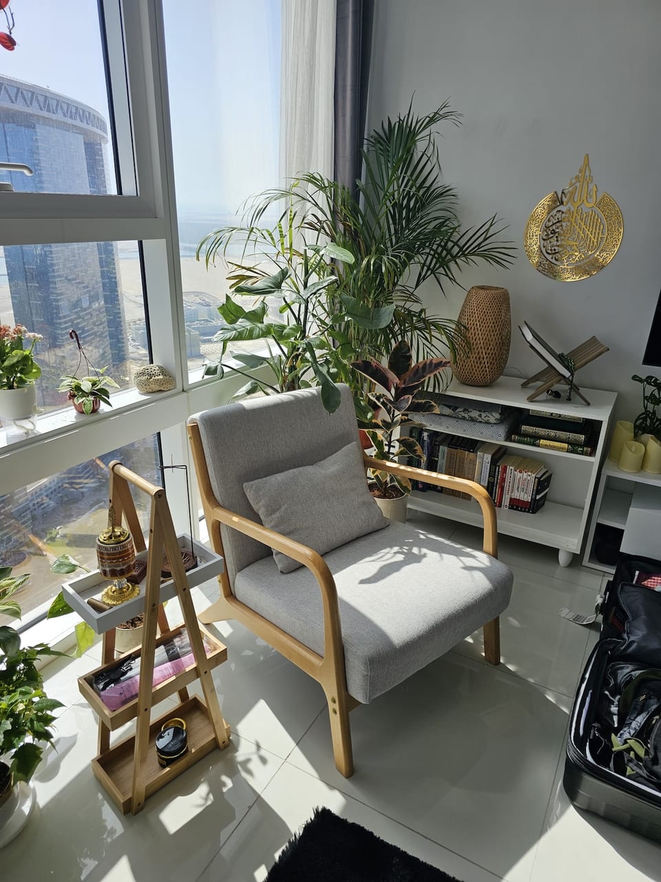 Reading Nook: Nestled by the window, a cozy reading area invites you to unwind with a good book while soaking in the stunning skyline views. The plush chair and modern floor lamp create a perfect corner for relaxation.