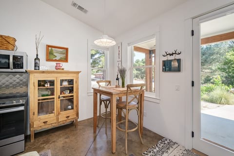 Dining table with view of the farm and the barn. There is also a dining table outside on the covered porch.