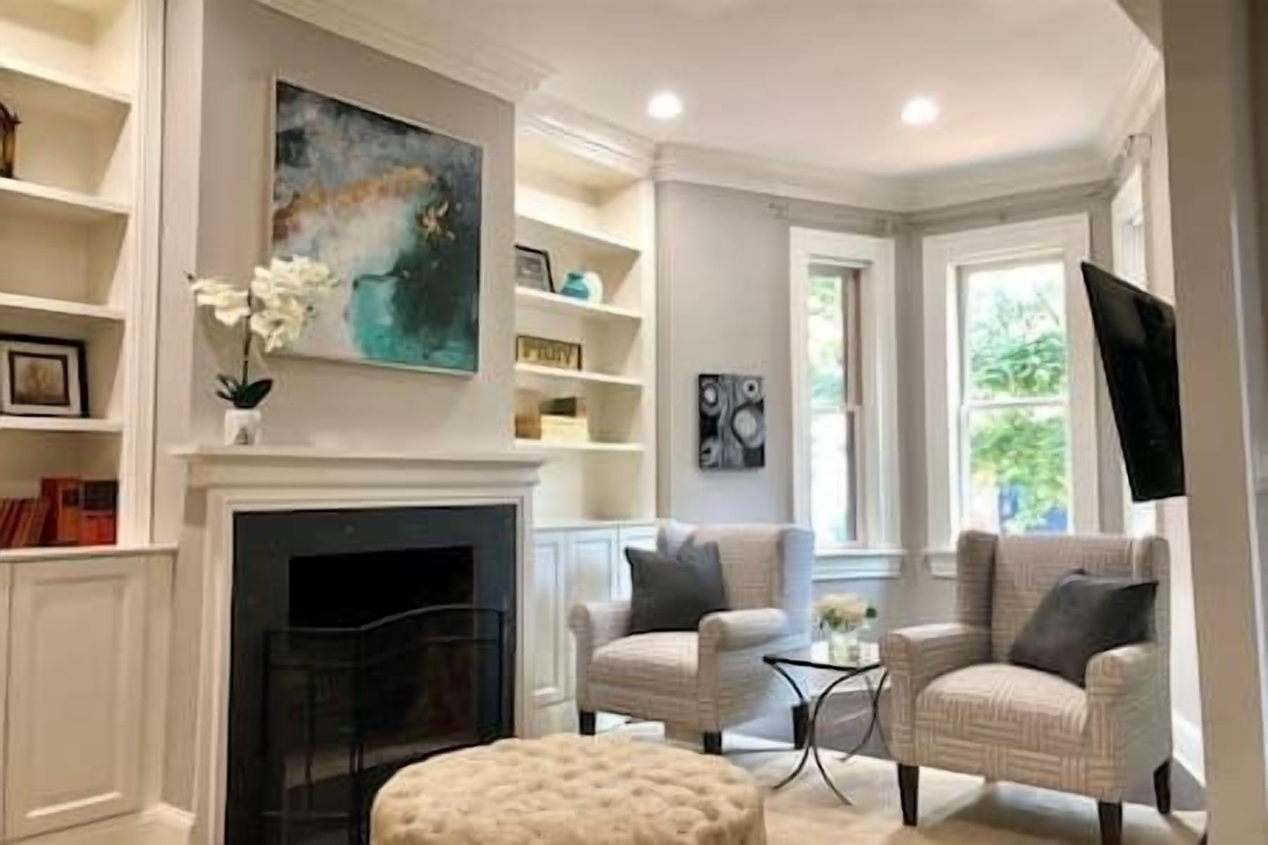 Step inside this elegantly styled living room with custom built-ins, cozy accents, and beautiful natural light to welcome you.
