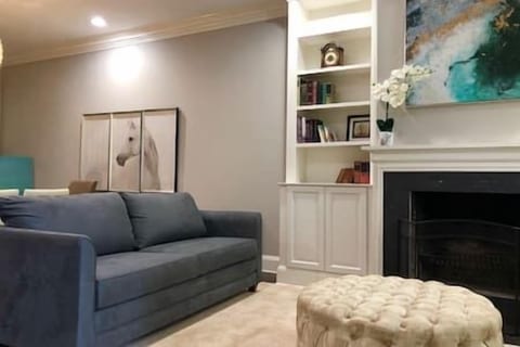 The queen sofa bed offers stylish versatility—relax during the day, unwind into comfort at night, all anchored by a tufted ottoman and elegant décor.