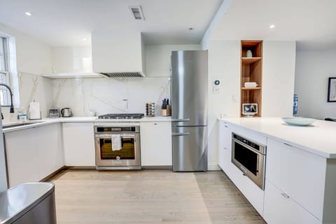 Kitchen: Stainless Steel KitchenAid Appliances, Gas Cooktop & Vent Hood.