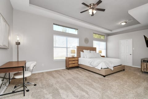 Your private retreat—stretch out in this spacious king bedroom with a work station, smart TV, and cozy lighting.