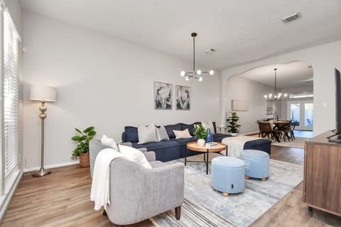 Thoughtfully decorated with stylish accents, creating a warm and inviting ambiance. Spacious living room with modern furnishings, streaming TV, and reliable WiFi. Ideal for families, relocations, or work-from-home stays.