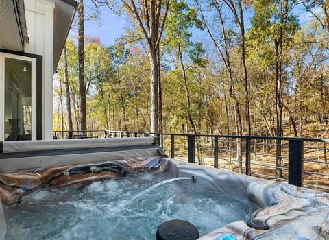 Private hot tub overlooking the woods—perfect for soaking, relaxing, and enjoying the peaceful nature views year-round.