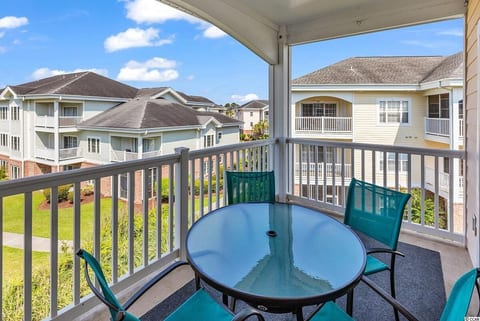 Private covered balcony with outdoor dining seating