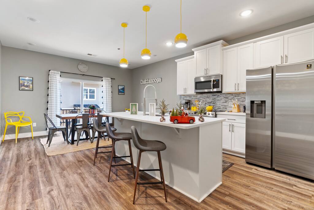 Bright and modern kitchen with stainless steel appliances, a spacious island, and seating for the whole group—perfect for cooking, dining, and gathering together