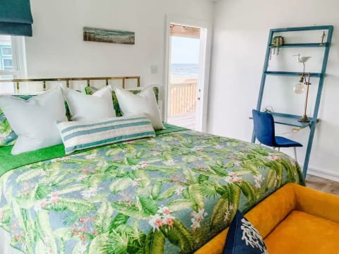Main level bedroom with king size bed and deck access