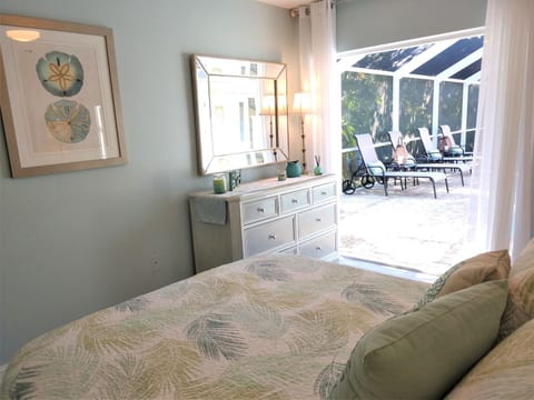 Bedroom #2, Queen bed, ceiling fan, TV plus french doors looking onto pool.