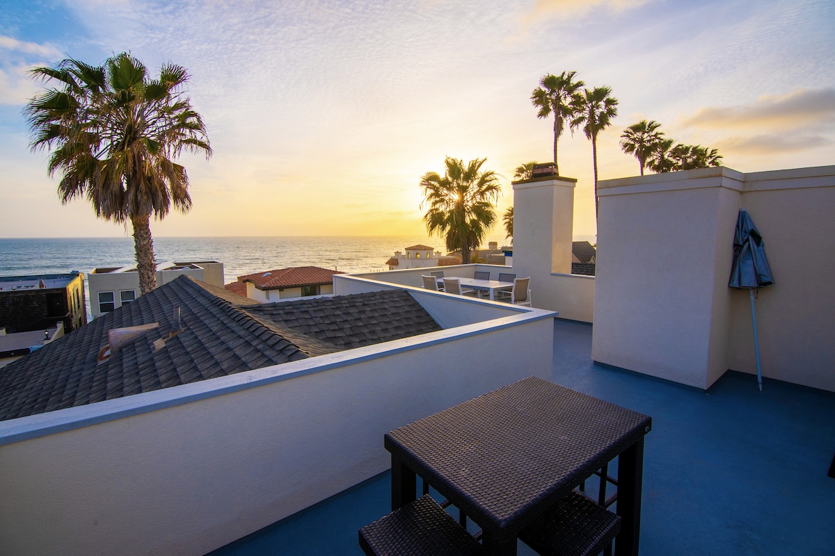 Rooftop deck with 2 counter height tables.
