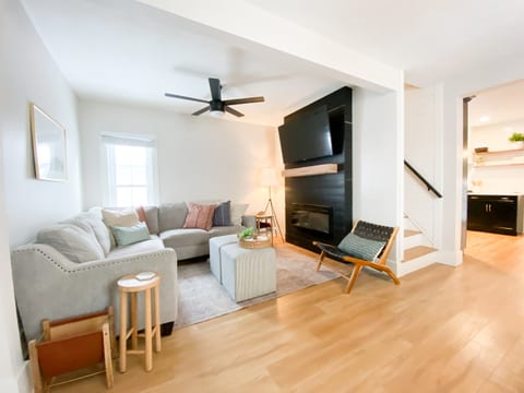 Bright living room with sectional sofa and smart TV