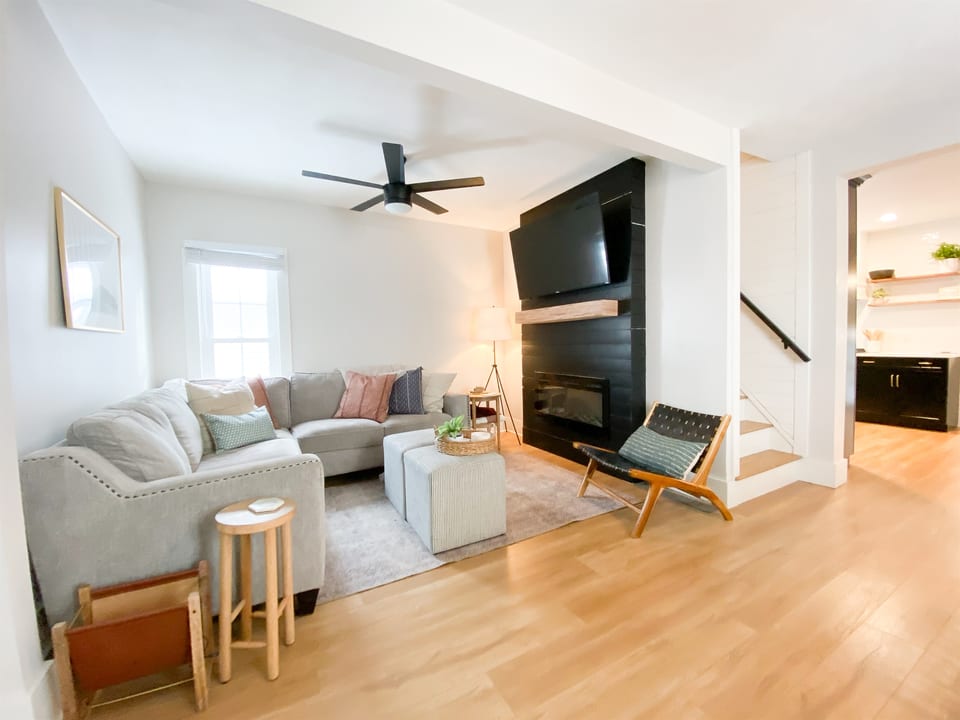 Bright living room with sectional sofa and smart TV