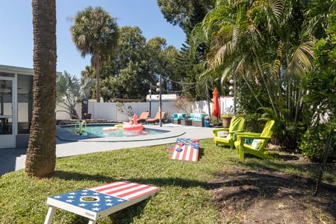 The sparkling pool is the centerpiece of this tropical oasis.
