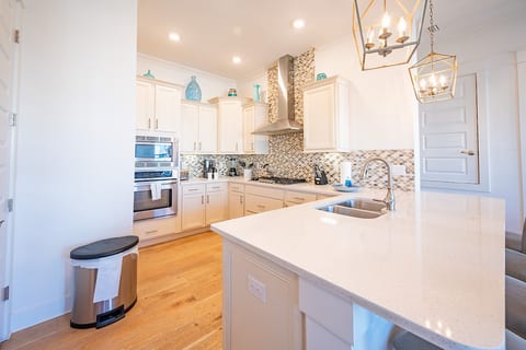 Fully equipped kitchen with high end stainless steel appliances and 4 bar stools.