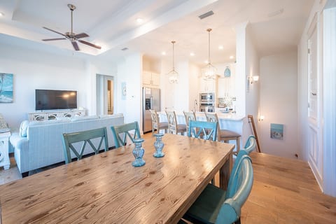Open floor plan with high ceiling, dining room, living room and kitchen.