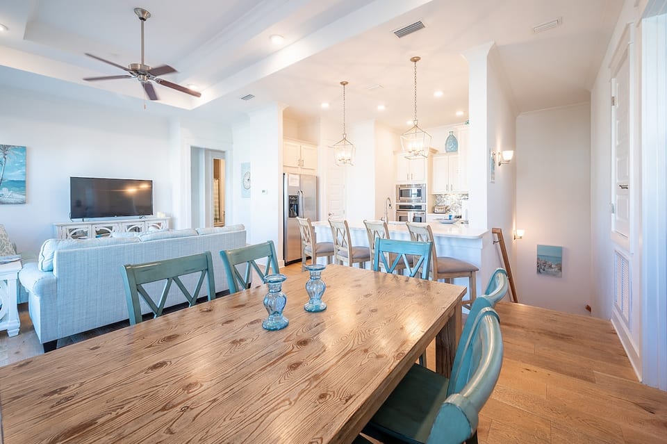 Open floor plan with high ceiling, dining room, living room and kitchen.