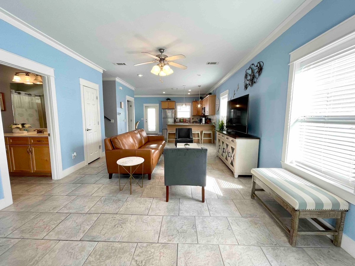 Open floor plan with living room, kitchen and bathroom. Comfortable seating to relax after a day at the beach.