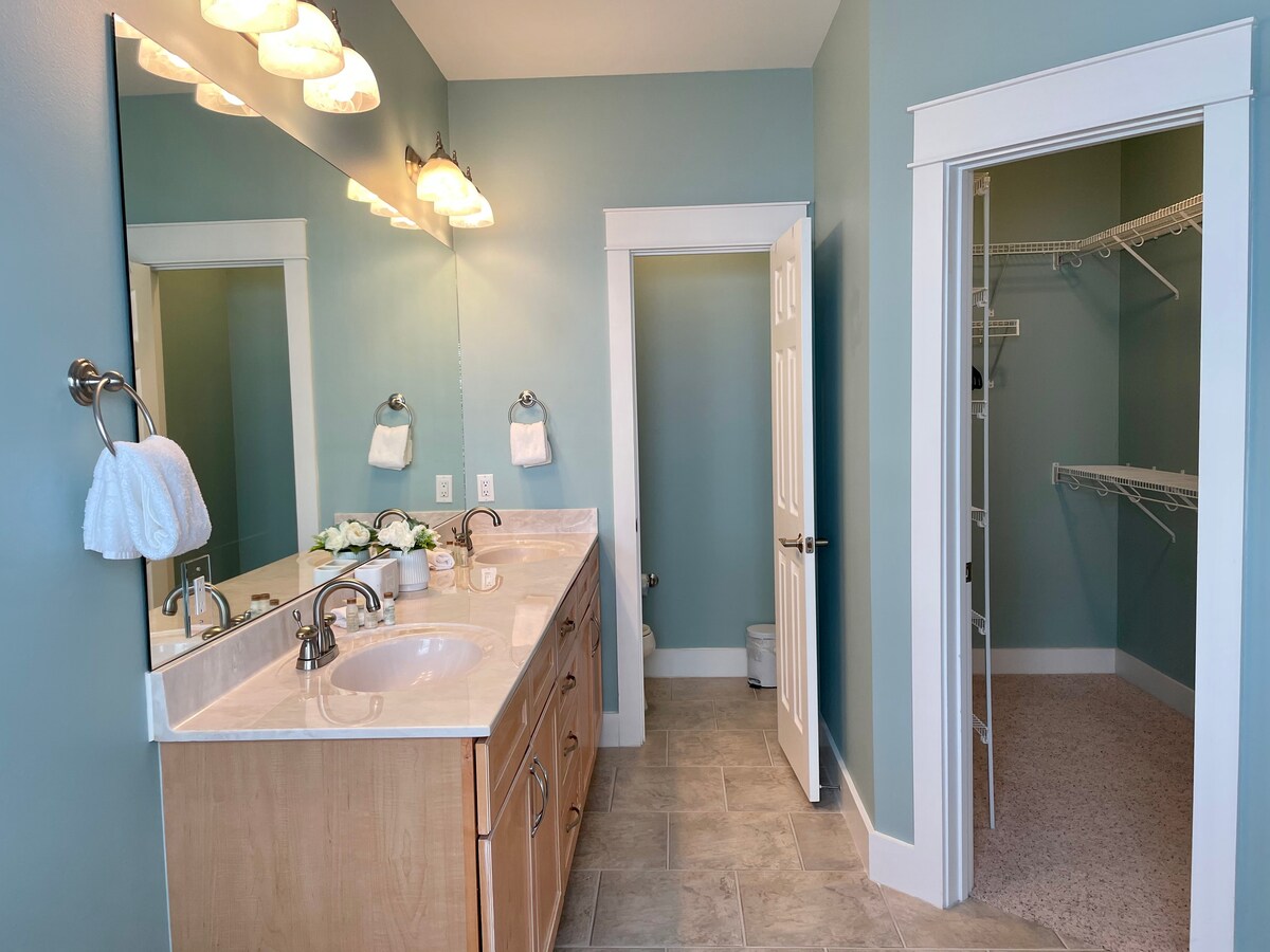 Master bathroom with double sink, private toilet and walk in closet.
