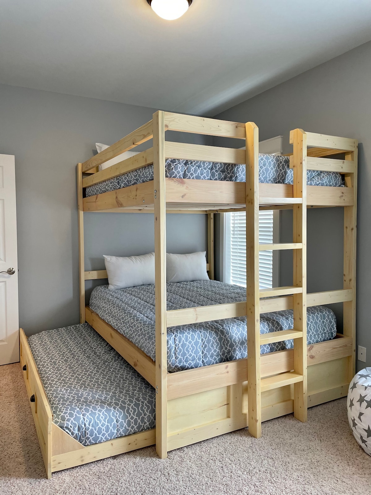 Tall queen over queen bunk-bed and twin trundle with comfortable foam mattresses