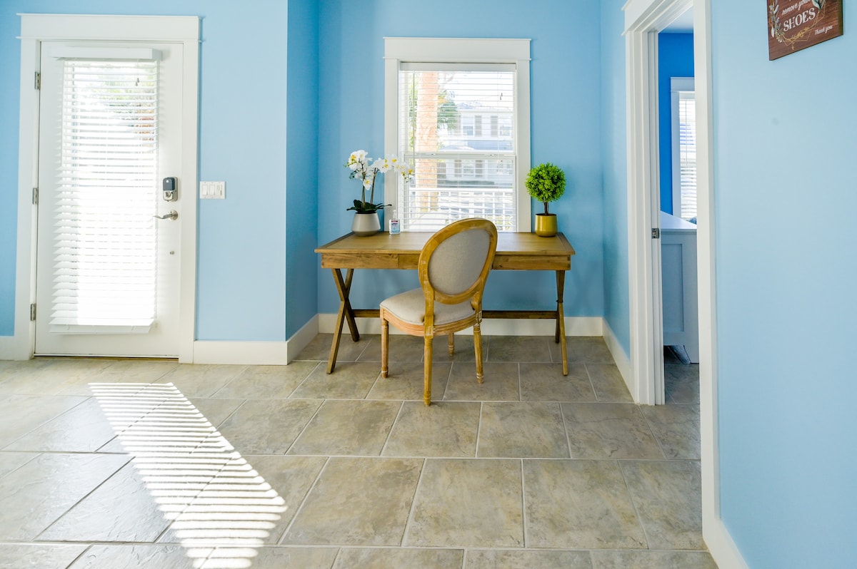 Front door entrance with desk and door to downstairs bedroom.