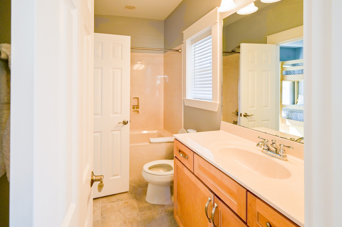 Upstairs jack and jill bathroom with tub and shower
