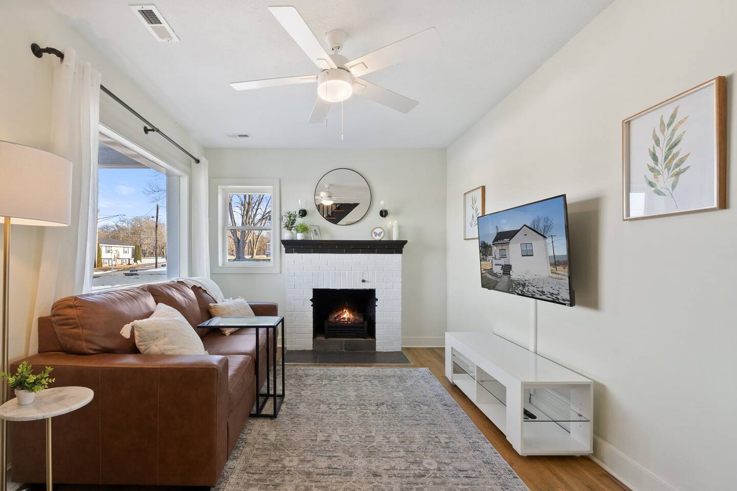 Living room with Smart TV, Couch, and Fireplace.