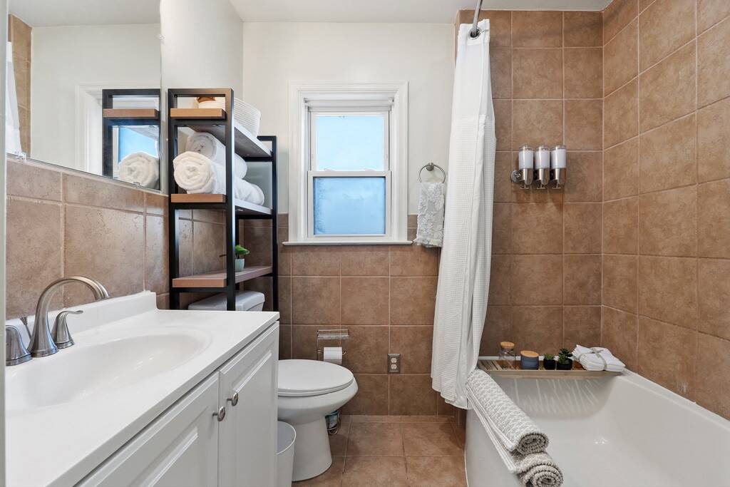 Nicely furnished bathroom with all the essentials: body wash, shampoo, and conditioner 