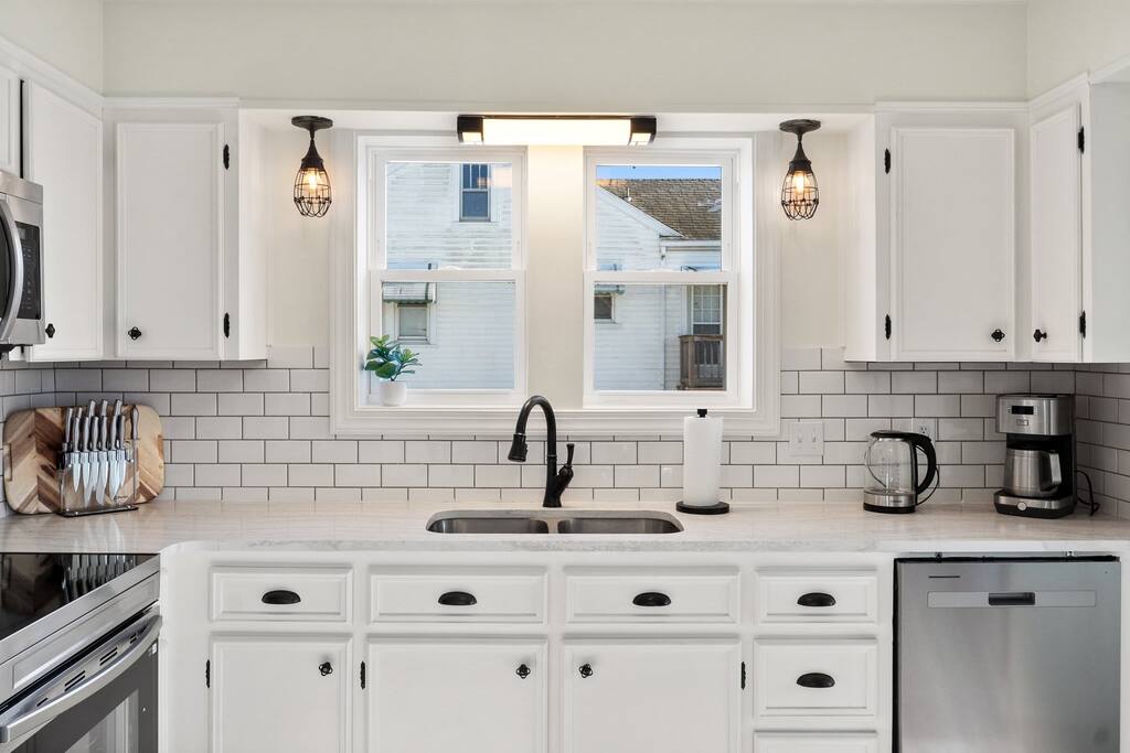 Fully furnished Kitchen. Sink, Range, Microwave, Tea Kettle, and coffee maker. Knives, Pots, pans, baking sheet and paper towels.
