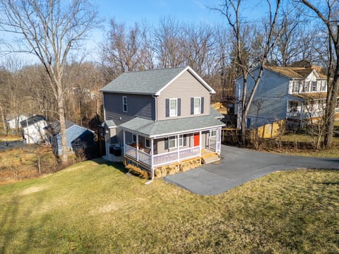 Cozy 2-story with wraparound porch, large yard & ample parking