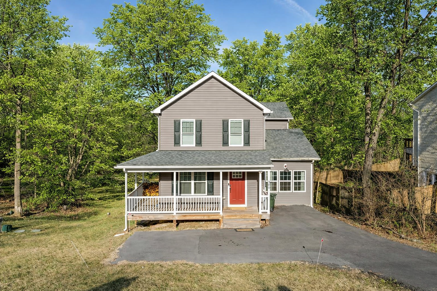Charming 2-story with covered porch, wooded privacy, and ample parking