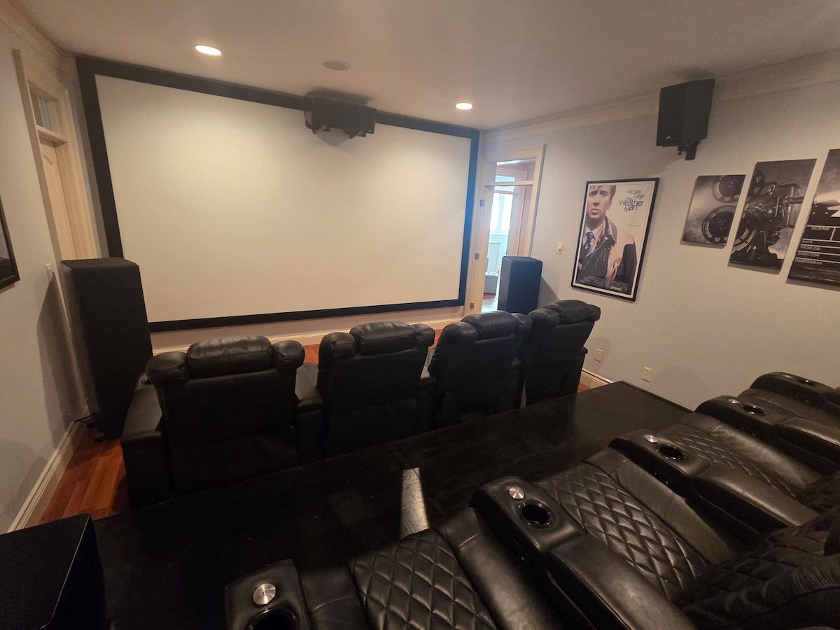 Private home theater with 7 luxury recliners, surround sound, and a large projection screen.