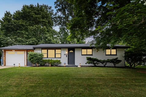 Front of home with a one car garage and room for two additional cars in the driveway.