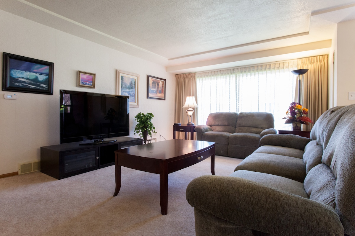 Living room with 65" HDTV with Netflix and YouTube TV (like cable with unlimited DVR) and a blu ray player!