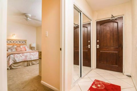 Front door, entry closet, and bedroom