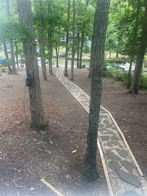 walkway down the backyard to the lake and the dock. This is the property and the lake which is part of the yard