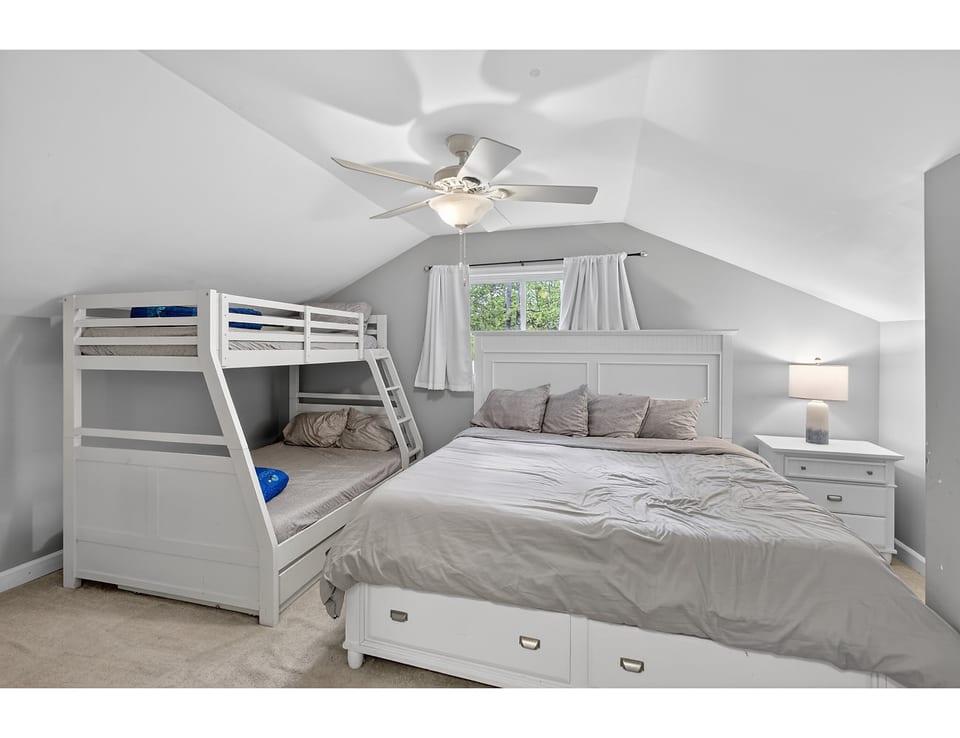 Family-friendly loft room with king + bunk, fan, and storage