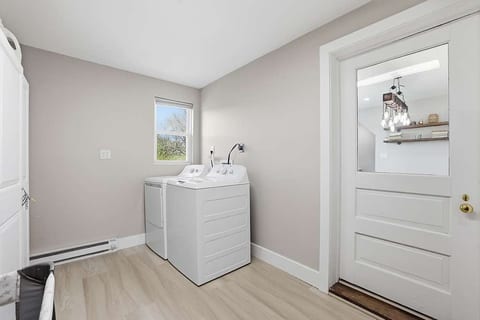 Bright, spacious laundry room with washer/dryer and natural light