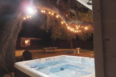 Indulge in ultimate relaxation, where an inviting outside jacuzzi awaits. Immerse yourself in the warm, bubbling waters as you unwind and rejuvenate amidst the serene outdoor setting.