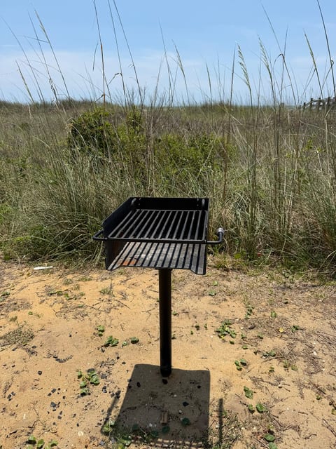 Coastal outdoor grill area nestled beside the dunes