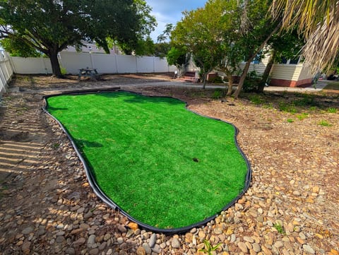 Private backyard putting green with shade trees and plenty of outdoor space
