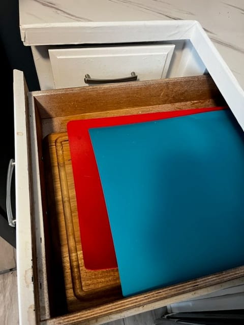 Well-stocked kitchen drawer with cutting boards for easy meal prep