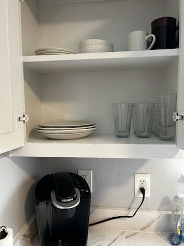 Well stocked kitchen. Kitchen cabinet with dishes, glasses, and convenient Keurig coffee