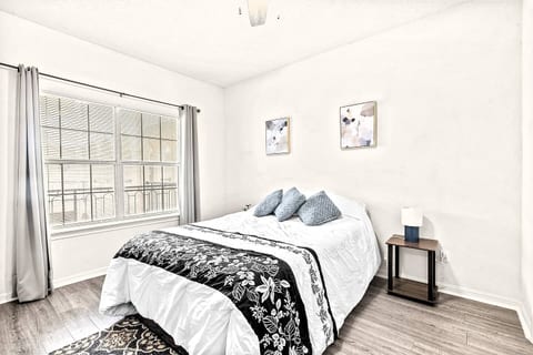 This bright and modern bedroom offers you a peaceful retreat to rest and recharge. You'll find a plush queen-sized bed, soft throw pillows, and two unique pieces of art. Enjoy a clean, minimalist space with a large window for natural light.
