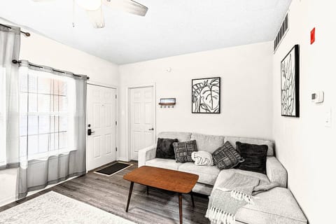 Welcome to your cozy retreat! Relax on the comfortable sectional sofa with a soft blanket and throw pillows. Watch a show on the TV or enjoy a book in the bright, inviting living area.