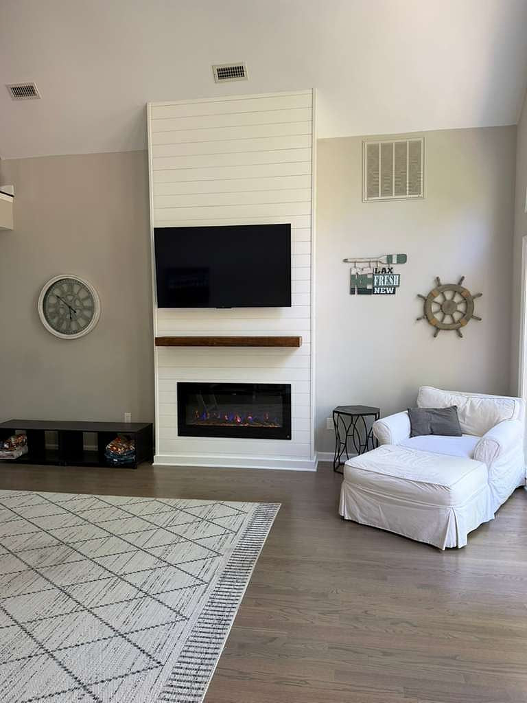 Cozy living room: NEW electric fireplace, wall-mounted TV, plush chaise lounge