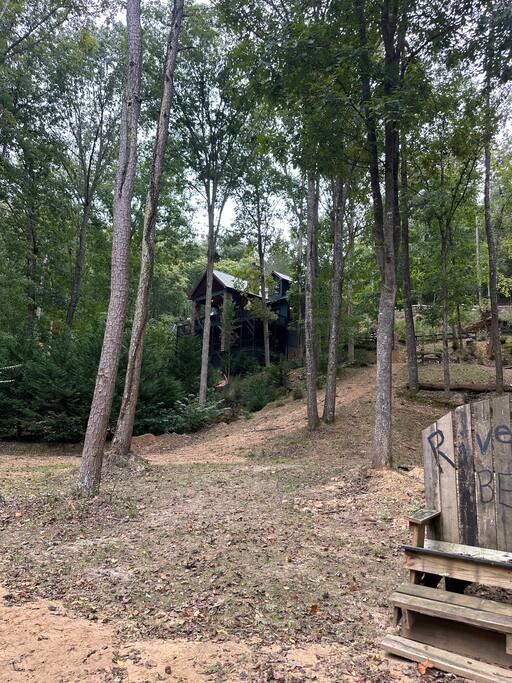 The backyard goes on and on! Located on a horseshoe of the river and on several lots and 3 acres, this cabin has the best location!  This is another view from near the river, as it wraps around the property. 