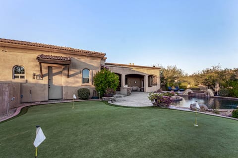 Sink putts on your private green, then unwind by the rock waterfall pool! Enjoy outdoor living, refreshing dips, & endless fun in your exclusive backyard oasis. You deserve this luxury escape!